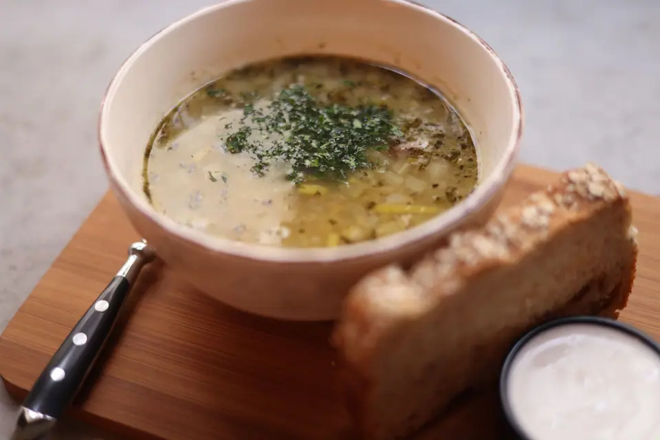 Soup and Bread Served in a Restaurant 